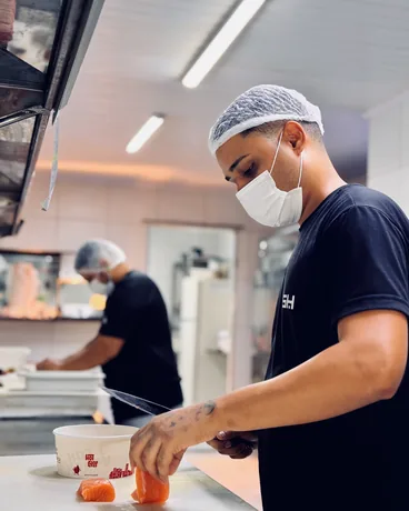Preparo do salmão na cozinha de uma unidade